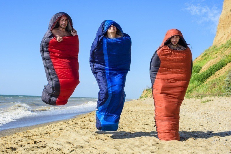 Happy Jumping Campers in Sleeping Bags