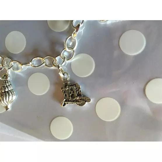 Beautiful 'Always at home wherever we roam' charm bracelet decorated with shells, caravan, lollies, sand castle, and ice cream charms perfect gift image 3